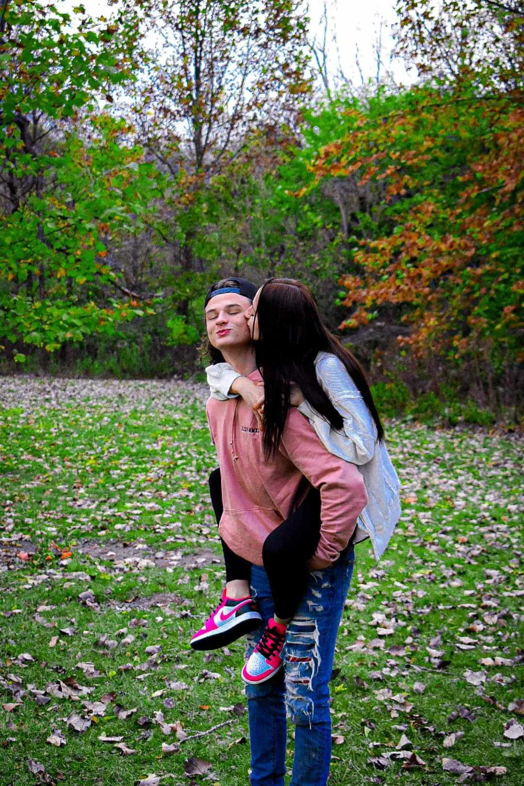 Young couple piggyback kiss on cheek, sweet and affectionate